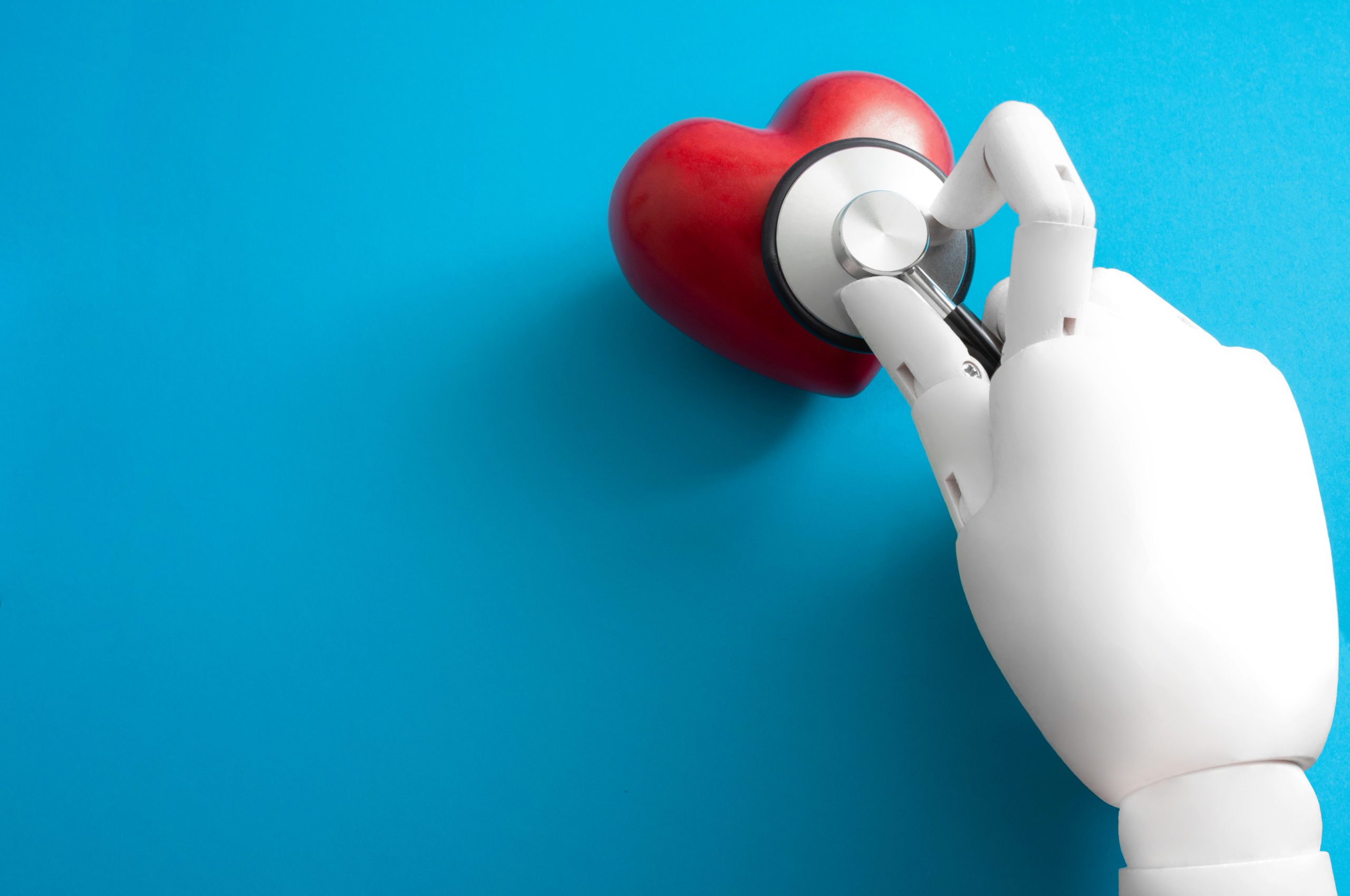 A robotic hand using a stethoscope to examine a red heart model on a blue background, representing the evolution of pain management.