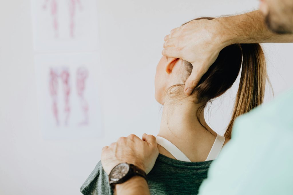 chiropractor working on a female patient's neck issue.