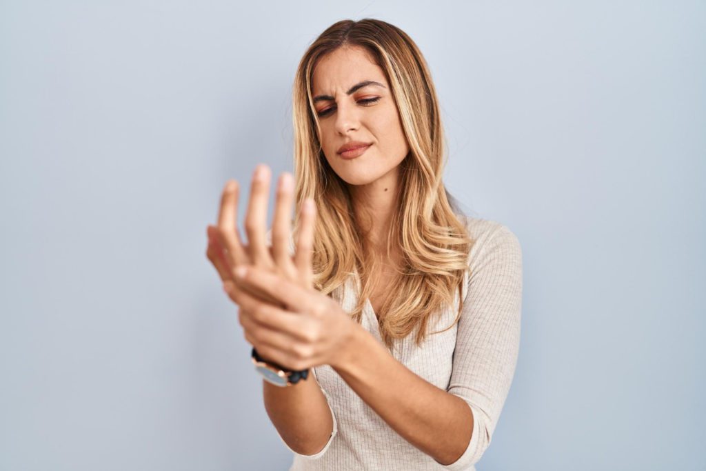 Woman holding her hand with arthritis.