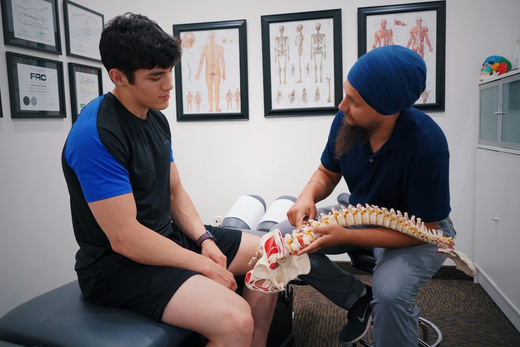 Physician going over spinal heath techniques with patient.