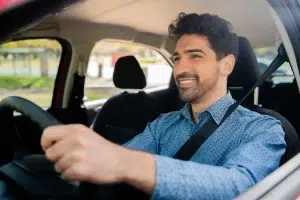Driver wearing a seat belt while driving, representing road safety, seat belt laws, vehicle safety requirements, and safe driving tips in Florida.